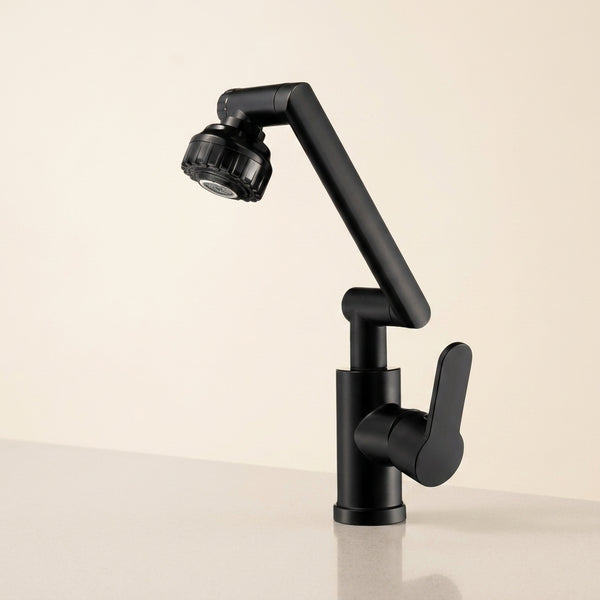 Llave monomando negra de cocina con caño articulado 180 grados, fondo crema