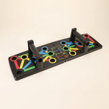 Tablero push-up fitness con mangos giratorios y circulos de colores, fondo crema